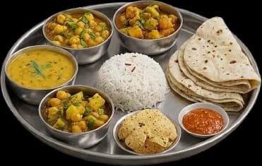 A brass thali — dal, two sabzis, rice, roti and pickle